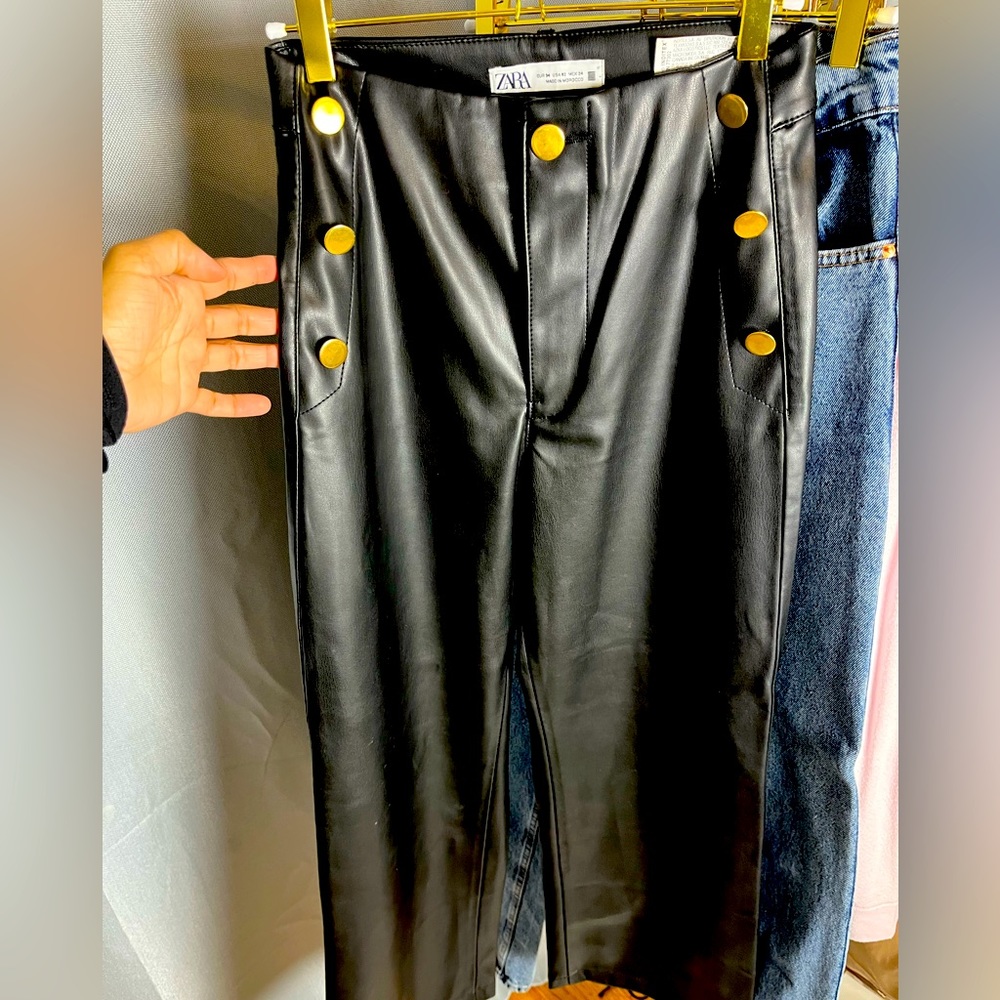 Ankle length black pleather pants, gold button detail